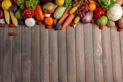 Fresh organic vegetables on wooden background